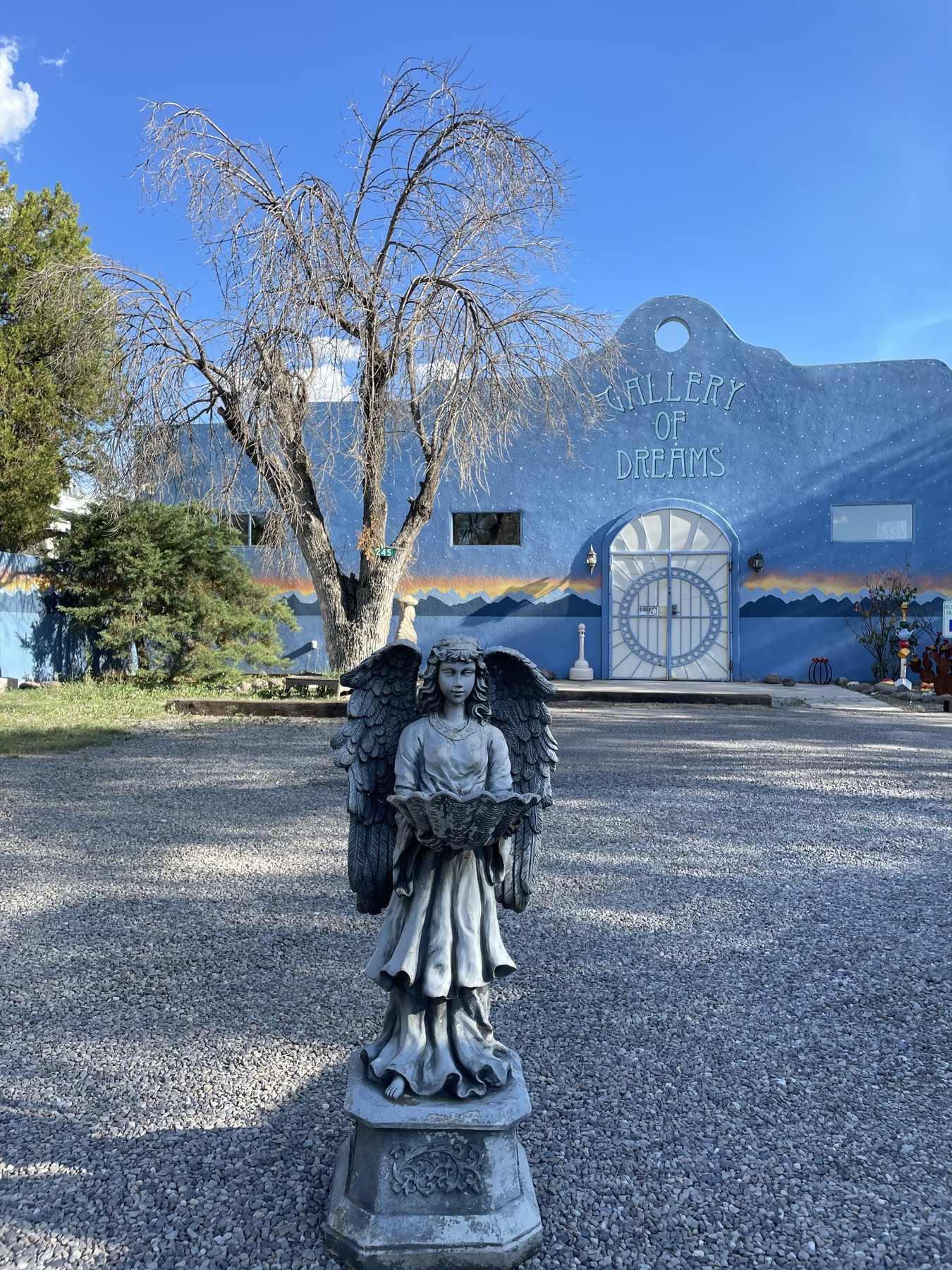 Serafina at a blue roadside stop with mountains in the background.