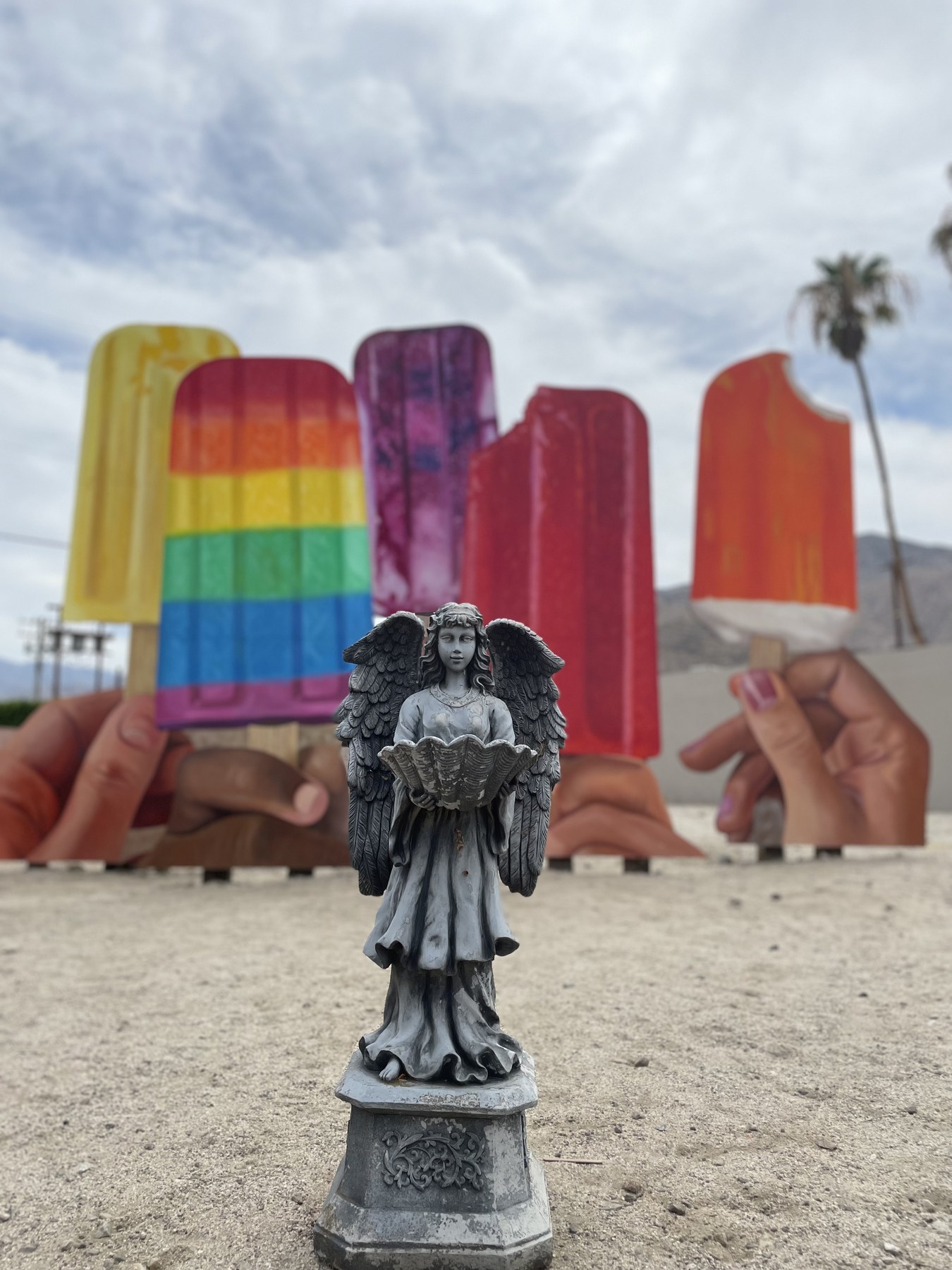 Serafina posed in front of giant colorful roadside popsicle sculptures.